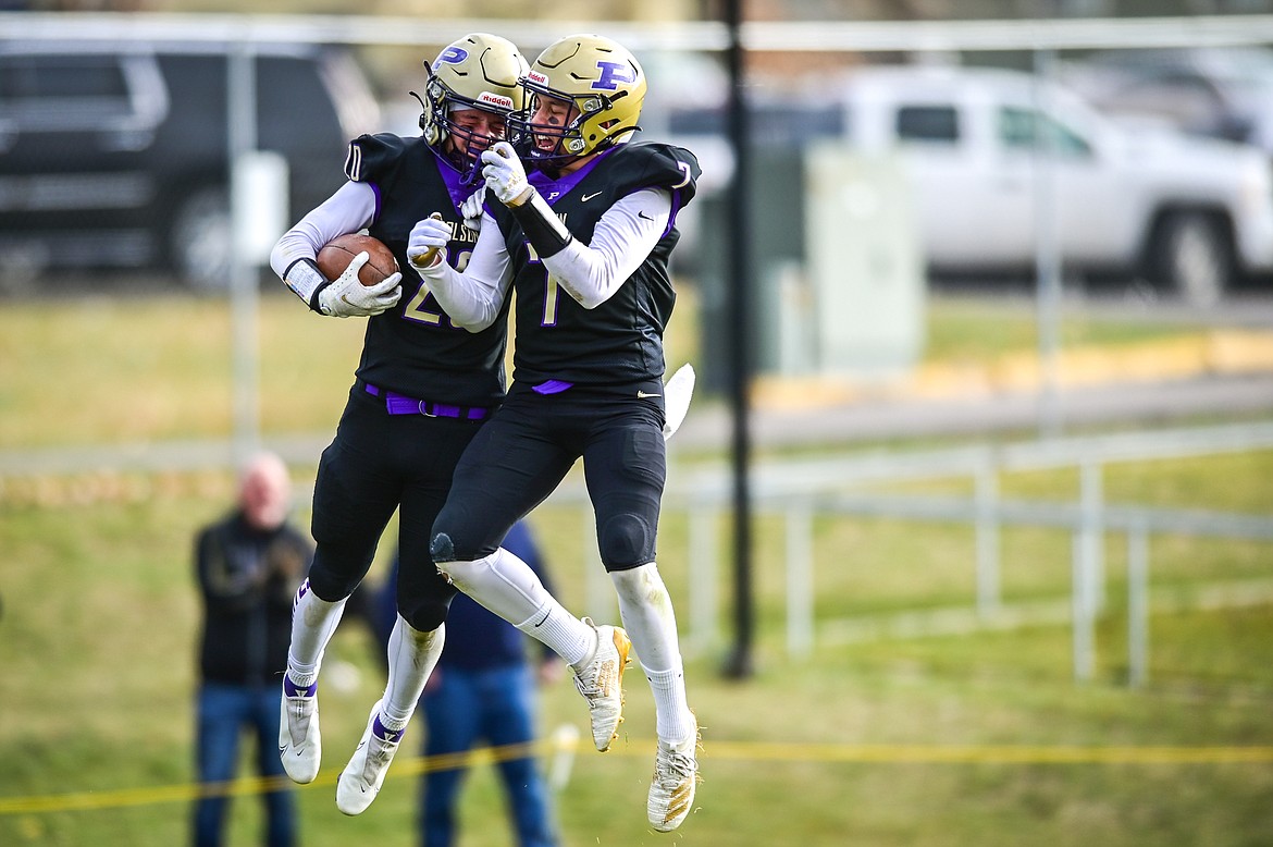 Polson wide receivers Xavier Fisher (20) and Alex Muzquiz (7) celebrate after Fisher's touchdown reception in the fourth quarter against Billings Central at Polson High School on Saturday, Nov. 6. (Casey Kreider/Daily Inter Lake)