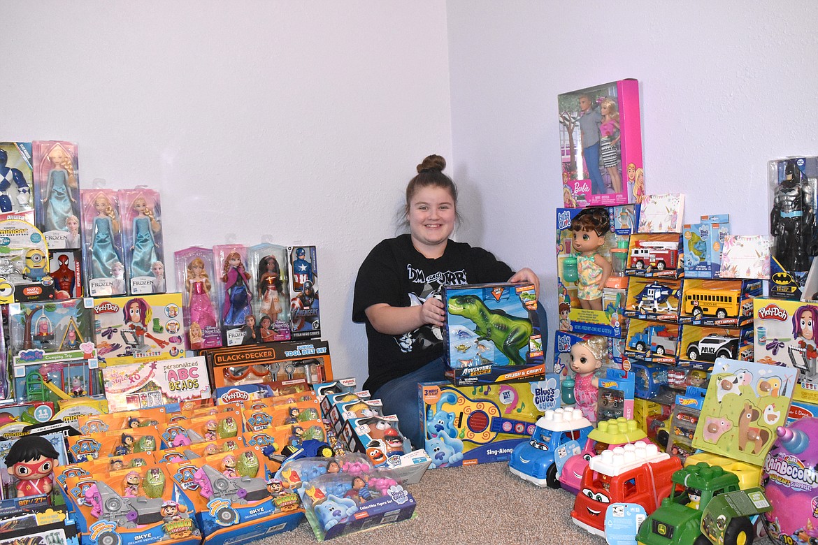 Lorelai Draper poses with some of the toys she has collected so far in her toy drive.