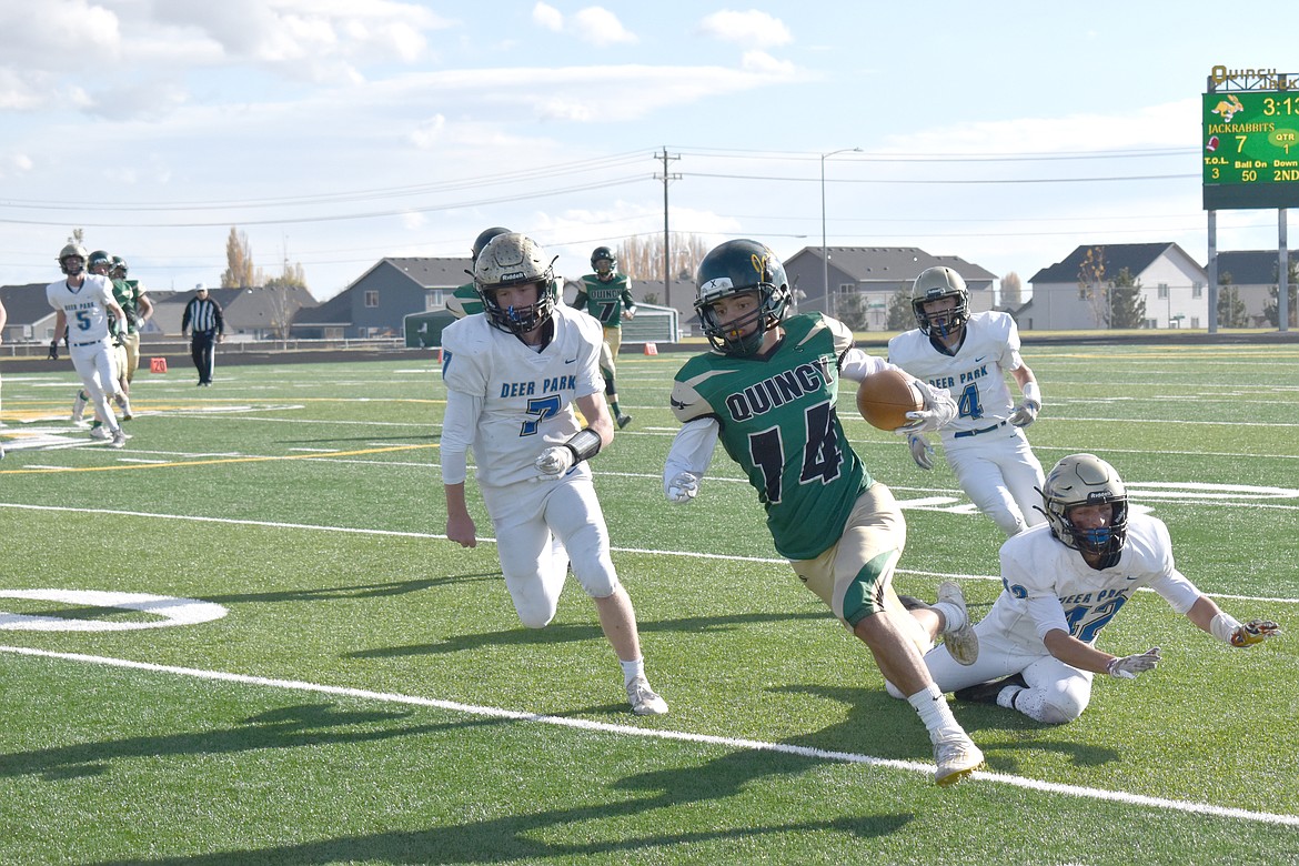 Several Deer Park High School players attempt to take down Quincy’s Jalen Spence (14) during the game Saturday.