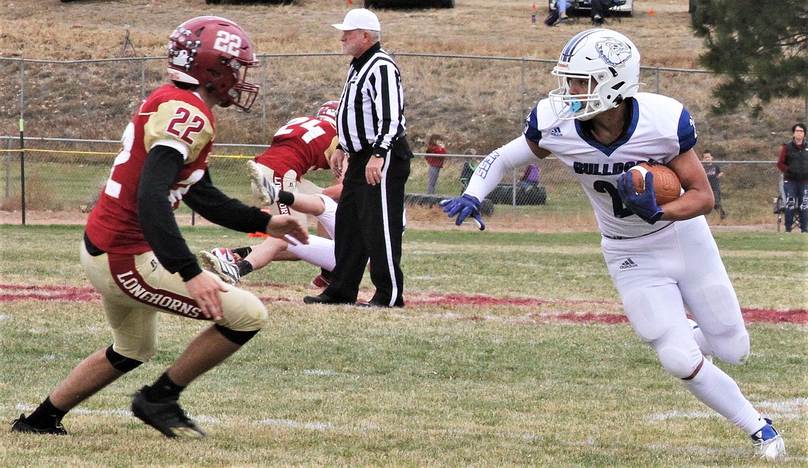 Kenny Ness looks for some running room during Mission's quarterfinal game at Fort Benton. (Courtesy of Daisy Adams)