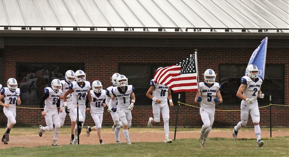 The Mission Bulldogs take the field before their 8-man state quarterfinal game at Fort Benton. (Courtesy of Daisy Adams)