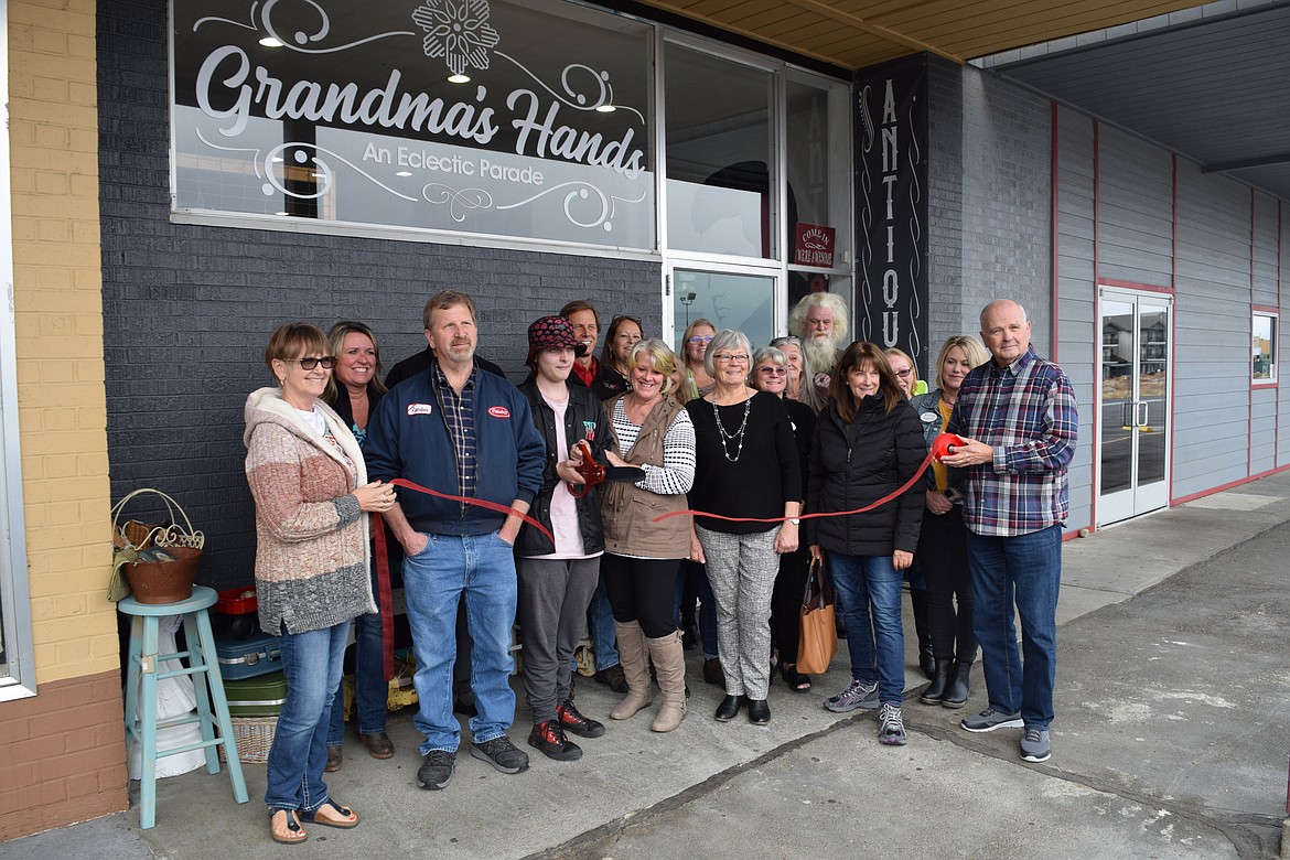 Tristan Dalrymple, with his grandparents Melody and Lyndon Price and members of the Moses Lake Chamber of Commerce, cuts the ribbon Friday afternoon on Grandma’s Hands, an “eclectic parade” of vintage items, home decor and all-natural bath products the Prices opened at 530 W. Valley Road in the Vista Village shopping center in Moses Lake.