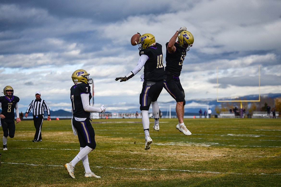 Colton Graham (10) and Braunson Henriksen jump in celebration beside Alex Muzquiz (7) after Polson a touchdown against Billings Central. (Casey Kreider/Daily Inter Lake)