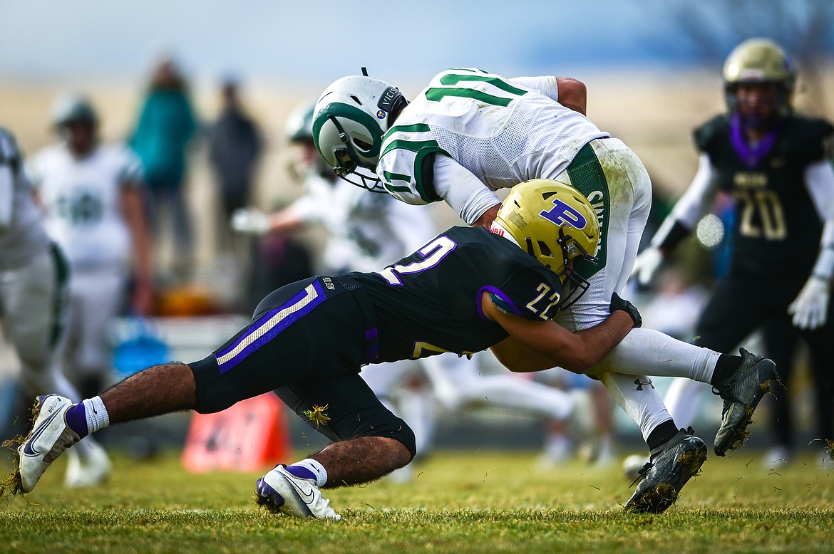 Jaren Keene wraps up Rams running back Kade Boyd. (Casey Kreider/Daily Inter Lake)