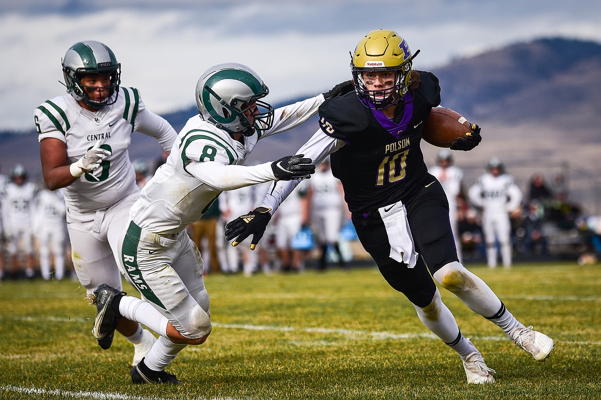 Colton Graham looks for running room as the Rams' Xavier Brackenridge (6) and Travis Hadley 98) give chase. (Casey Kreider/Daily Inter Lake)