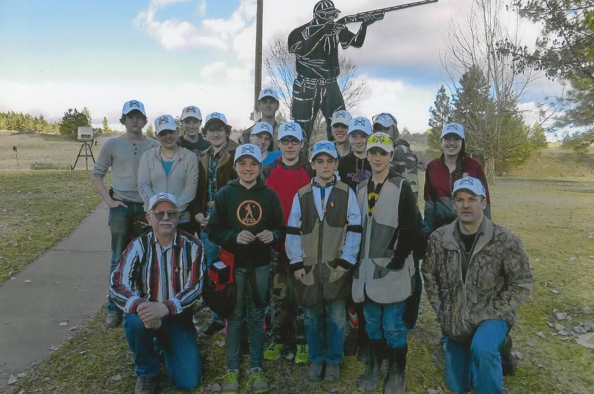 Plains 4-H shooting coaches Mike Blake, far left front, and Matt Cockrell, far right front, have led the program for nine years. (Courtesy photo)