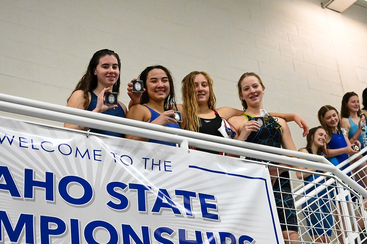 From left: Ryleigh Bamer, Ayiana Prevost, Ava de Leeuw and Emily Ballard pose for a photo after placing second in the 400 free relay.