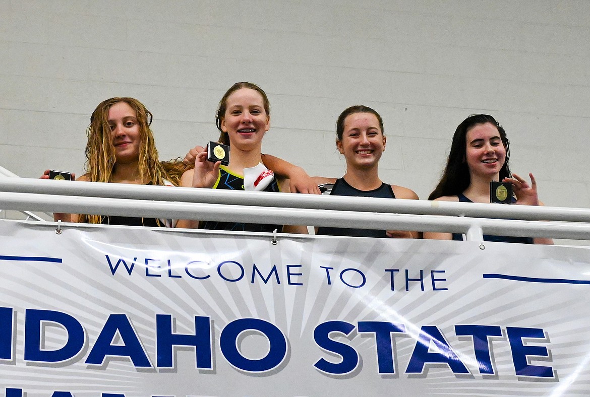 From left: Ava de Leeuw, Emily Ballard, Maren Davidson and Ryleigh Bamer pose for a photo with their medals after winning the state title in the 200-yard freestyle relay on Saturday.