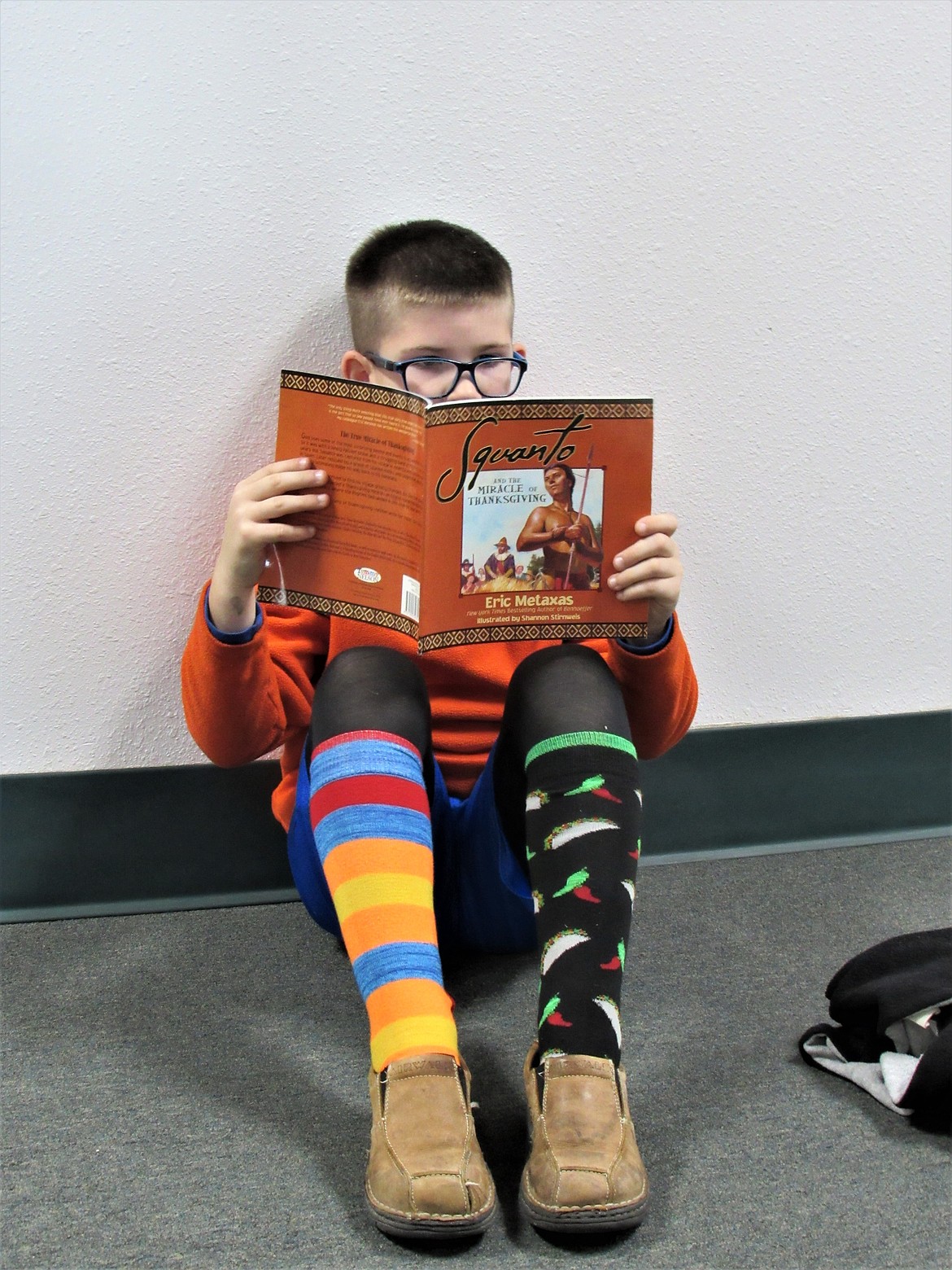 Student reading during Crazy Sock Day at Idaho Hill Elementary.