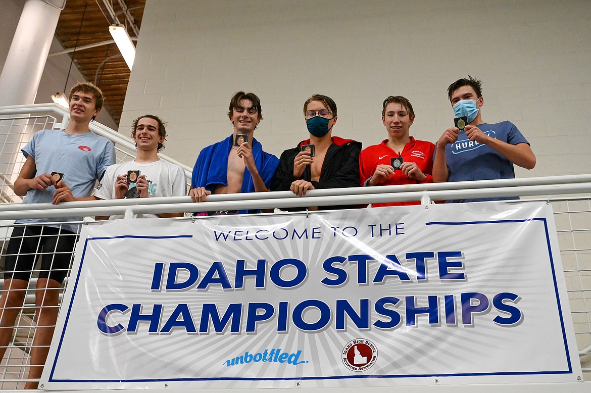 Hayden Leavitt (second on the right) poses for a photo with his runner-up medal in the 50 freestyle.
