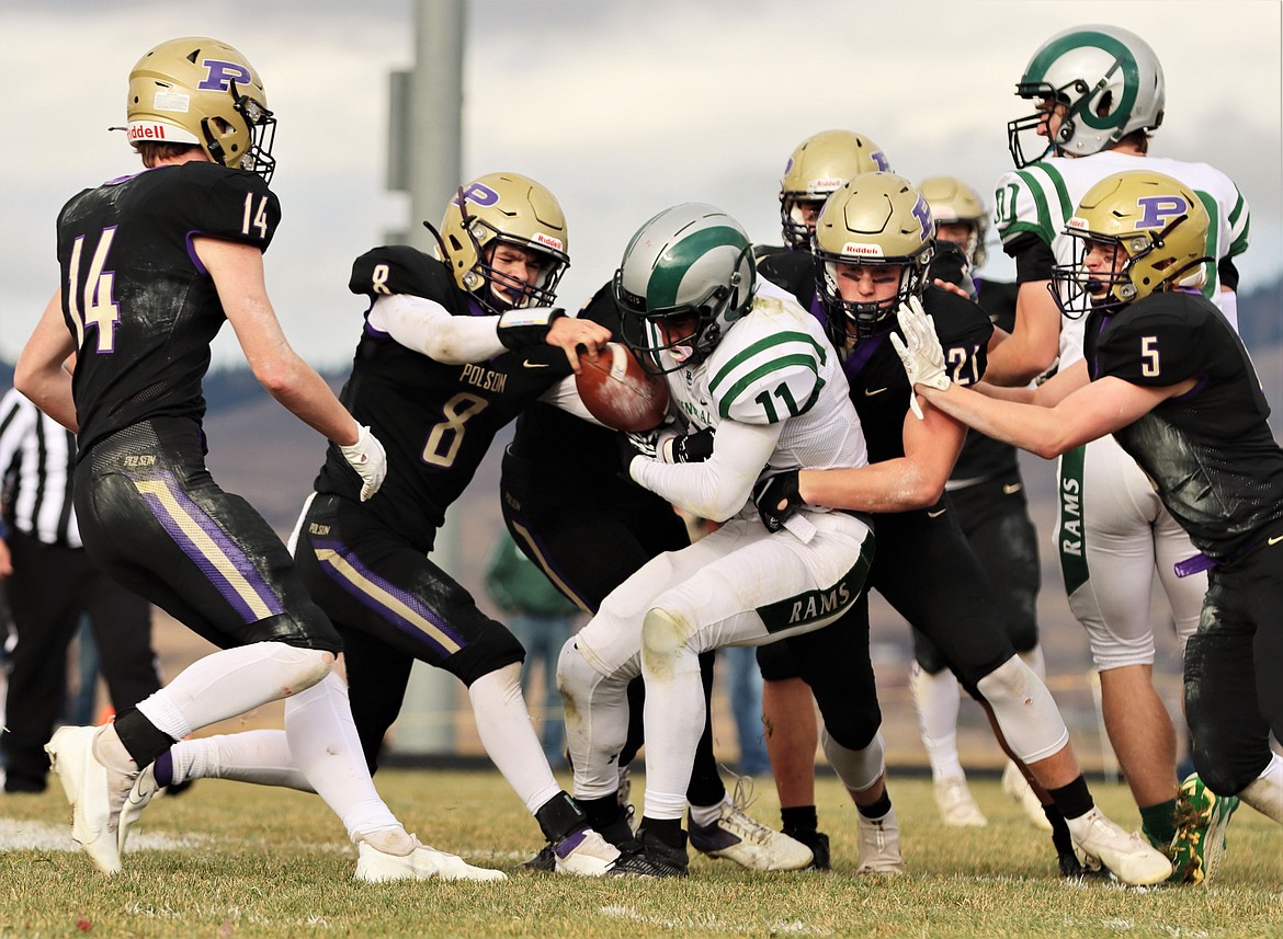 Playing defense, Polson Jarrett Wilson (8) strips the ball from Rams running back Kade Boyd. Wilson took the ball the distance for a Pirates touchdown. (Courtesy of Niki Graham)