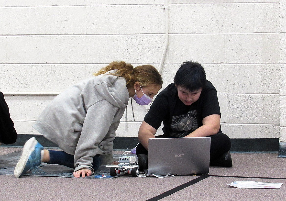 A pair of Idaho Hill students check over their project as their work on Ozobots and robots during a recent visit by UI's NASA team to the school.