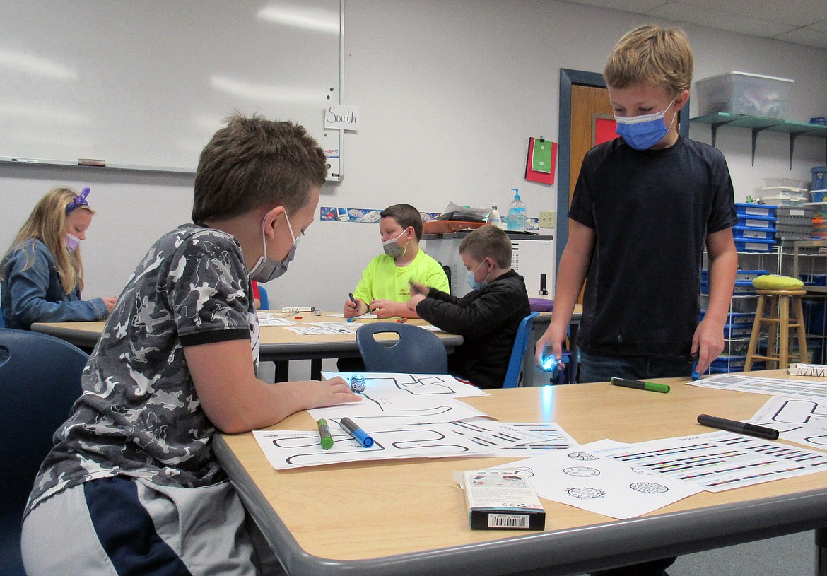 Idaho Hill Elementary students work on a project during a recent visit by University of Idaho's NASA team to the school. Among the projects were Ozobots and robots.