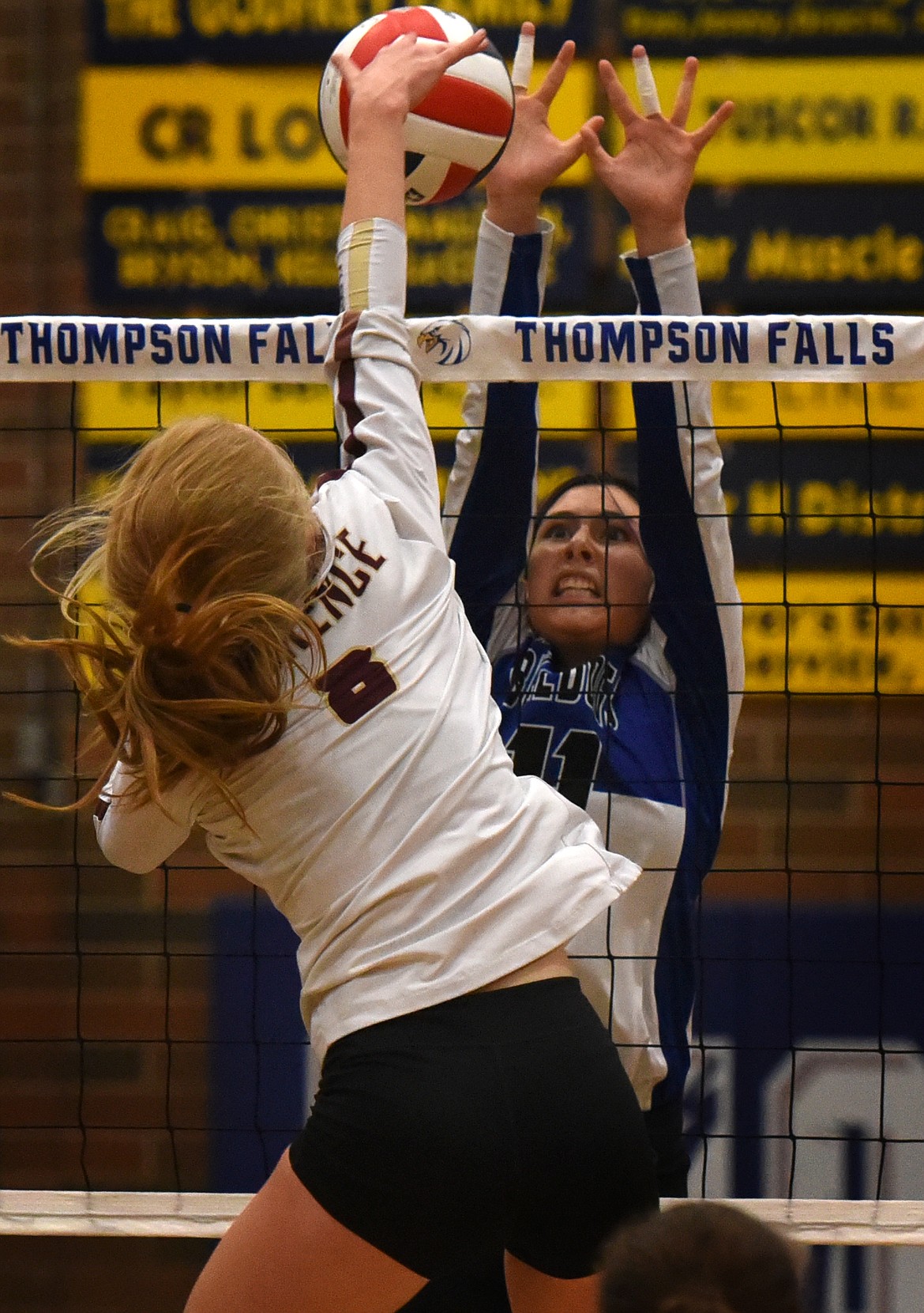 Mission's Rowan McElderry goes above the net to block an attack from Florence-Carlton's Elsie Schienter at the Western B Divisional volleyball tournament in Thompson Falls. (Jeremy Weber/Daily Inter Lake)