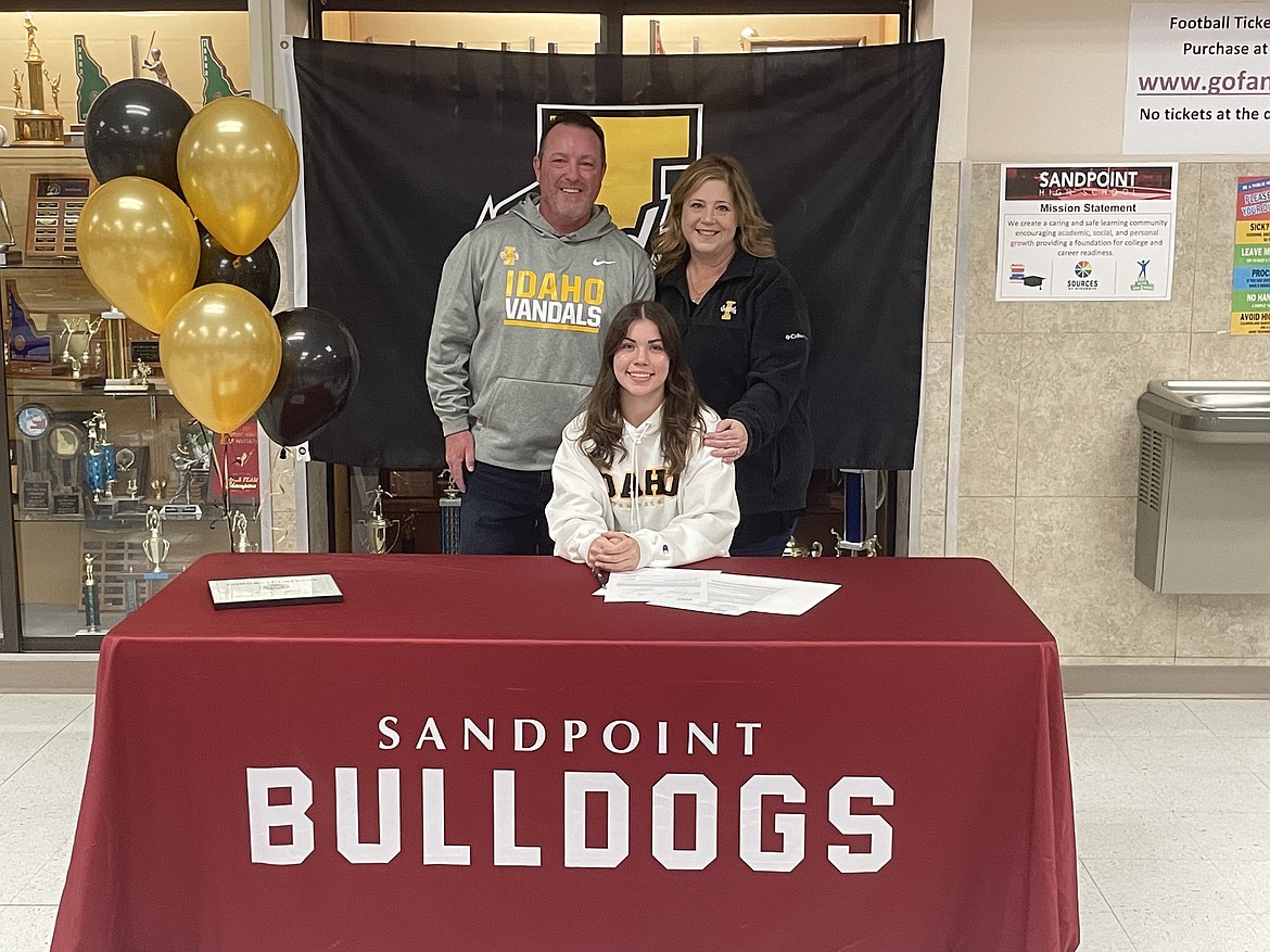 Sierrah VanGesen poses for a photo with her parents after signing her NLI on Wednesday.