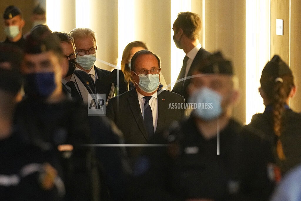 Former French President Francois Hollande, center, arrives at the special courtroom to testify in the Nov.2015 attacks trial, Wednesday, Nov. 10, 2021 in Paris. Hollande was at France's national stadium when a suicide bomber blew himself up outside the gates on Nov. 13, 2015, the first in a series of attacks that would last three more hours across Paris. Gunmen struck cafes and bars in the city center, and the night culminated with a bloody siege at the Bataclan concert hall. In all 130 people died in the attacks. Hollande ordered the final assault on the three remaining attackers inside the Bataclan. (AP Photo/Michel Euler)