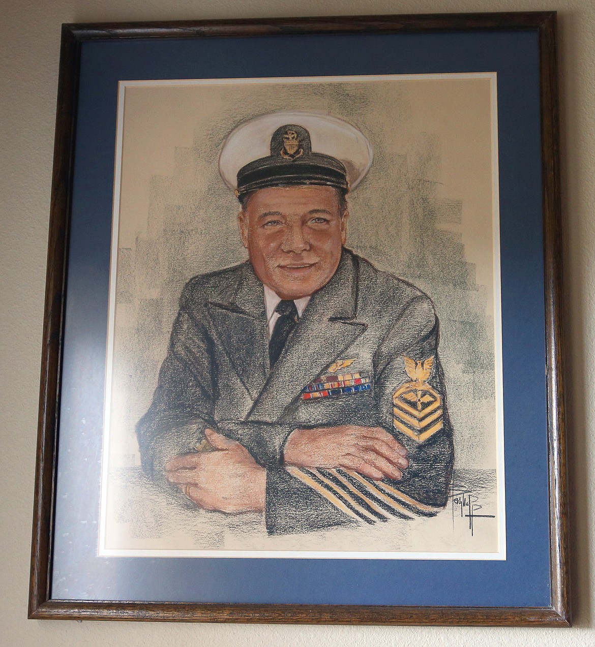 An artist portrait of Earl Carroll during his Coast Guard career is played on the wall of his Coeur d'Alene home.