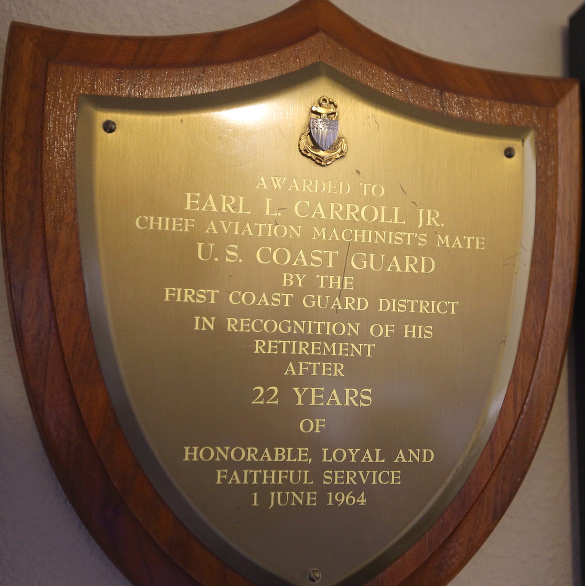 A plaque honored Earl Carroll's 22 years with the U.S. Coast Guard hangs on the wall of his home.