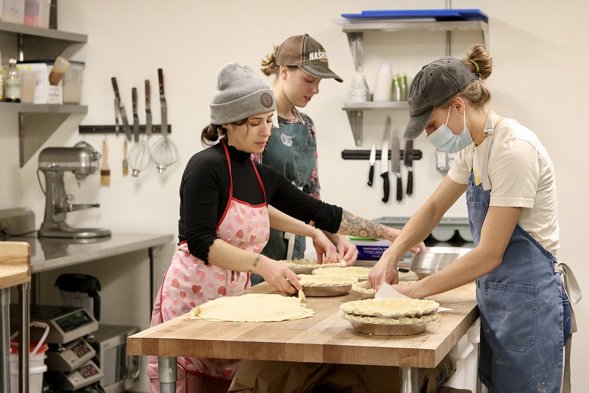 From left, Kendall Fetzer, Kailey Martinelli and co-owner Katy Bean create pies for their Thanksgiving orders at Bean & Pie in downtown Coeur d'Alene.