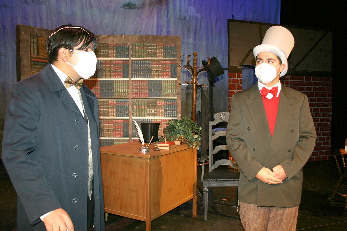 Scrooge (Aaron Cruz-Martinez, left) scolds his nephew Fred (Dawson Rubio) for his Christmas frivolity in the Quincy High School production of “A Christmas Carol.”