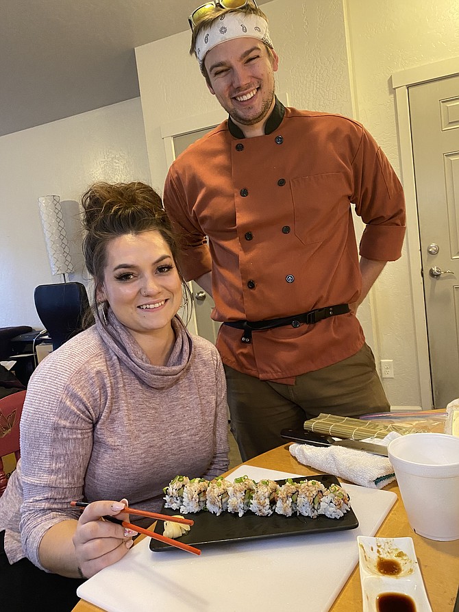 My Sushi Sensei Isaac Cunnington stands next to guest student Dakota Goldman and her beautifully displayed futo maki roll.