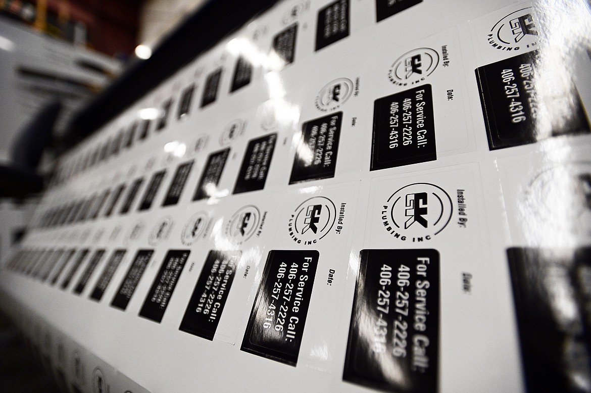 Glossy stickers are printed for a client on a solvent-based inkjet printer at Kalispell Copy Center on Thursday, Nov. 11. (Casey Kreider/Daily Inter Lake)