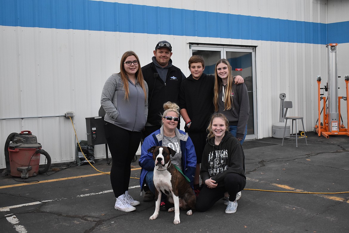 The Bronson family lost their home in a fire, but the generosity of dad’s employer is helping them get back on their feet. From left in the back: Emma Bronson, Jared Bronson and Joseph Bronson and family friend Mackenzie Hartman. In the front row: Lindsey Bronson, Meaghan Thomas and Dozer the dog.
