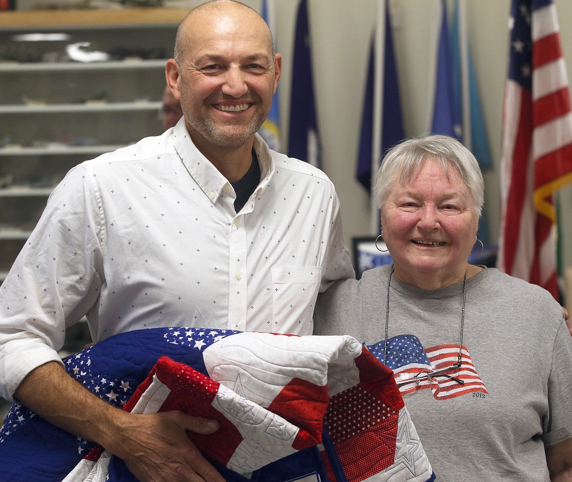 Veteran Todd Kerbs of Spokane poses with mom Joanne Kerbs of Post Falls following the Quilts of Valor presentation Thursday.