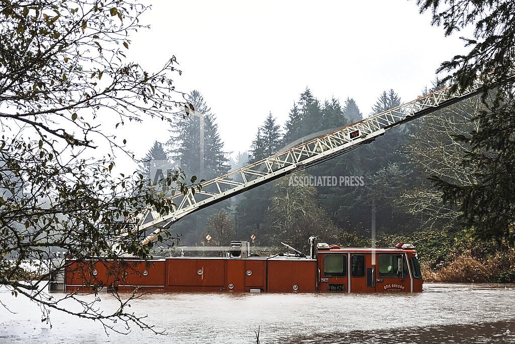 In this photo provided by the Lincoln County Sheriff's Department, a fire engine is surrounded by rising waters in Otis, Ore., Friday, Nov. 12, 2021. The U.S. Coast Guard has used two helicopters to rescue about 50 people from rising waters at an RV park on the Oregon Coast Friday as heavy rains in the Pacific Northwest prompted warnings of floods and landslides. (Sgt. Jack Dunteman/Lincoln County Sheriff's Department via AP)