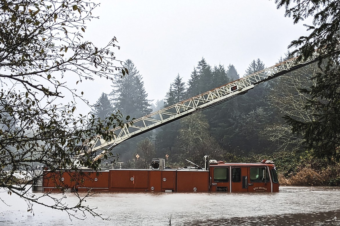 A fire engine is surrounded by rising waters in Otis, Ore., Friday, Nov. 12, 2021. The U.S. Coast Guard has used two helicopters to rescue about 50 people from rising waters at an RV park on the Oregon Coast Friday as heavy rains in the Pacific Northwest prompted warnings of floods and landslides. (Sgt. Jack Dunteman/Lincoln County Sheriff's Department via AP)