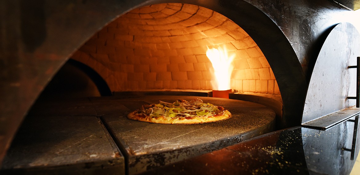 With his brick over, Nick Erickson is bringing the taste of fresh-baked pizza to Evergreen. (Jeremy Weber/Daily Inter Lake)