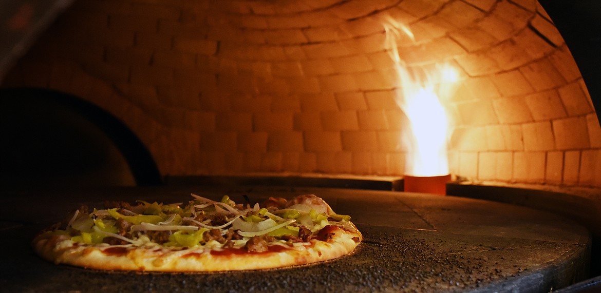 With his brick over, Nick Erickson is bringing the taste of fresh-baked pizza to Evergreen. (Jeremy Weber/Daily Inter Lake)