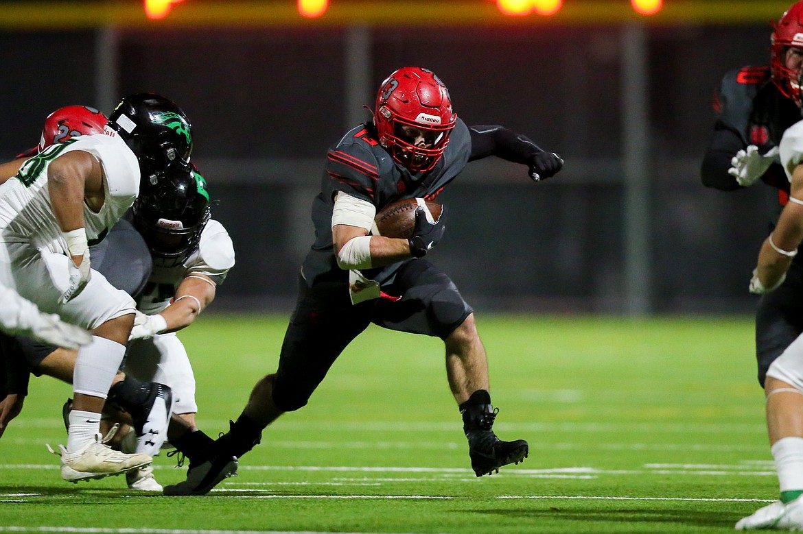 Running back Gerrit Cox finds a hole in the Blackfoot defense on Friday.