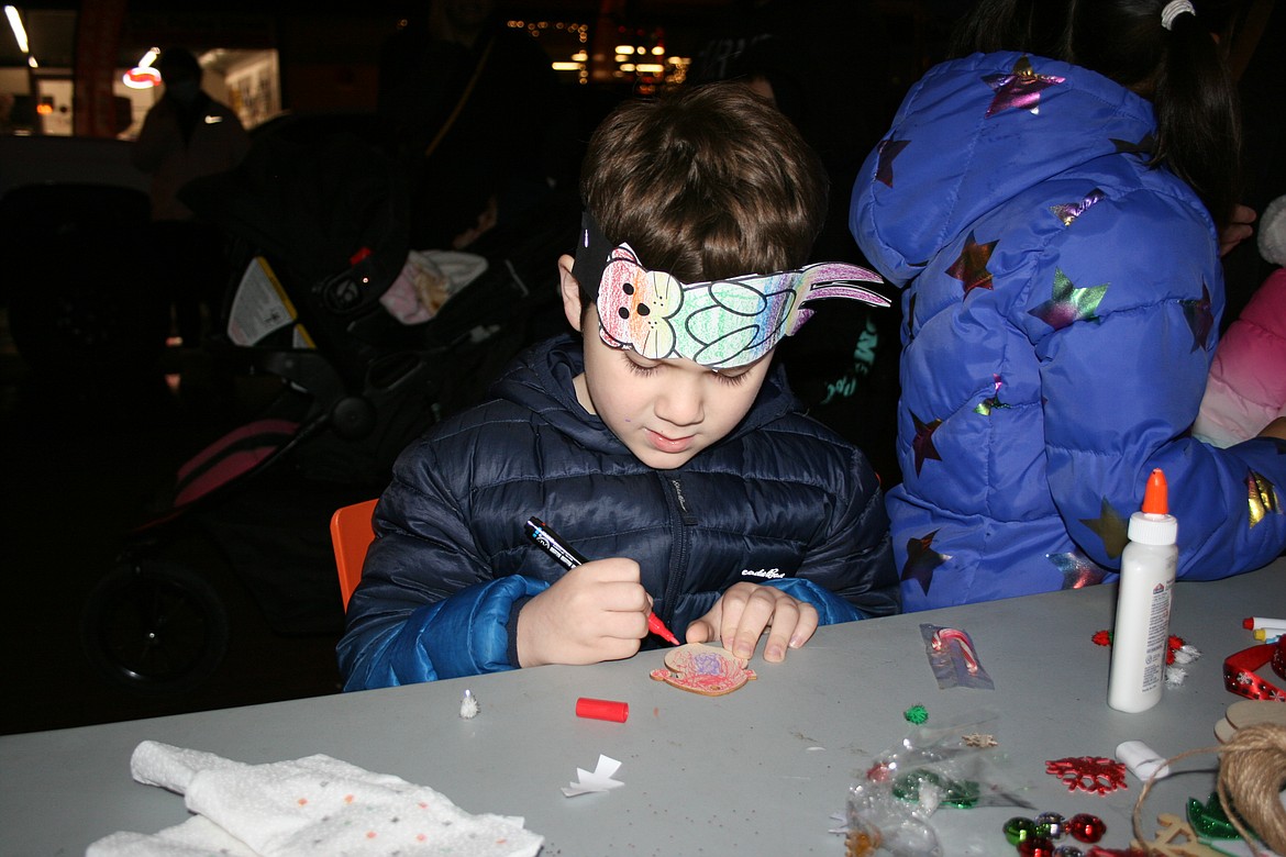 Kiyoshi Wagner paints an ornament during the Downtown Street Tree Lighting and Holiday Open House sponsored by the Downtown Moses Lake Association.