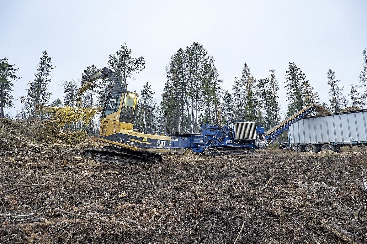 Casey Jump loads the Peterson wood recycler with slash. The chips are used in the company’s cogeneration plant, which, in addition to providing heat for the mill, also provides about 2.5 megawatts of electricity back to the grid. (Chris Peterson photo)