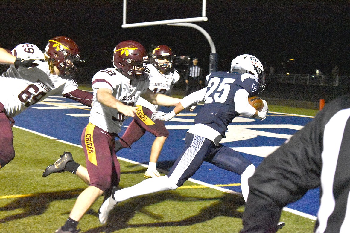A Gonzaga Preparatory School player heads into the endzone for a touchdown as Moses Lake players try to stop him at Friday’s game.
