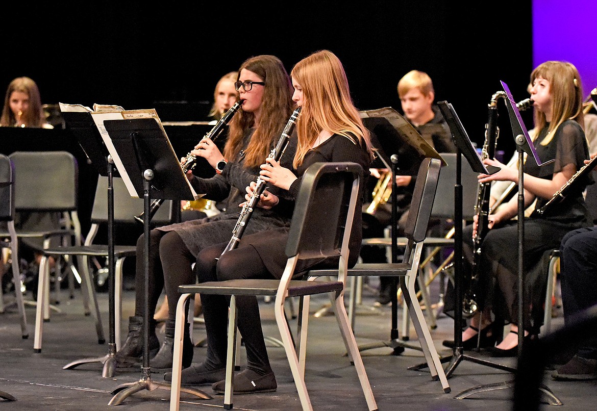 Whitefish Middle School students Ella Idleman and Allison Ponti play the clarinet, and behind them Sasha Johnston on the bass clarinet, with the eighth grade band at a recent fall band concert at the Whitefish Performing Arts Center. (Whitney England/Whitefish Pilot)
