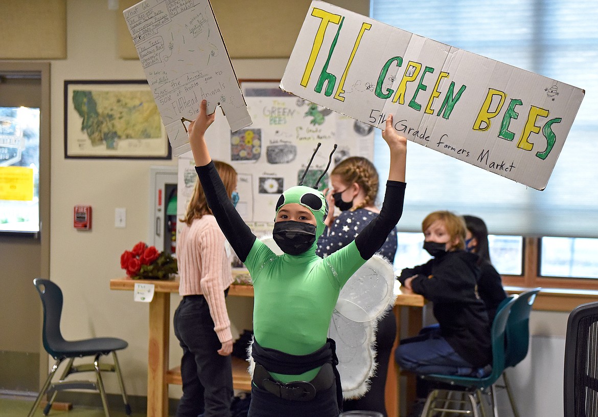 Whitefish Middle School student Solas Noftsinger dresses up as "The Green Bee" at the fifth-grade farmers market event at the Center for Sustainability and Entrepreneurship at the WHS campus on Wednesday, Nov. 10. Also on The Green Bees team in the background is, left to right, Vivian Hurst, Lucinda Preston, Avery Sivanish, and Eleanor Parsons.(Whitney England/Whitefish Pilot)