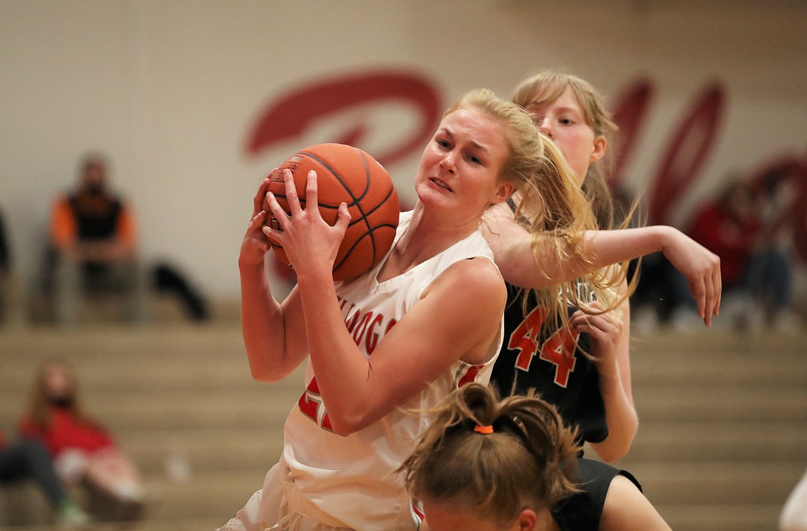 Sofia Platte battles for a rebound during a game against Post Falls last season at Les Rogers Court. Platte, a senior, will play a major role in the post for the Bulldogs this winter.