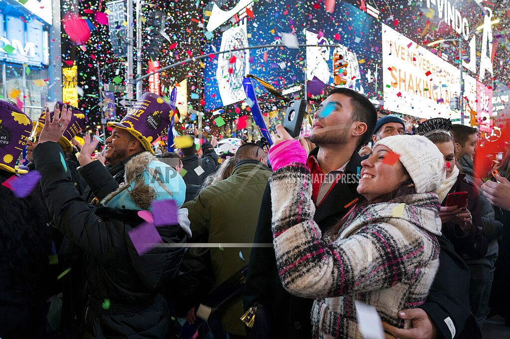 Confetti falls as people celebrate the new year in New York's Times Square, Jan. 1, 2017. Crowds will once again fill New York's Times Square this New Year's Eve, with proof of COVID-19 vaccination required for revelers who want to watch the ball drop in person, Mayor Bill de Blasio announced Tuesday, Nov. 16, 2021. (AP Photo/Craig Ruttle, File)