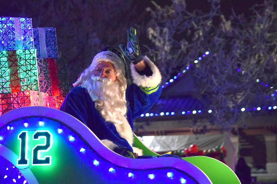 Santa in a Seahawk sleigh waves to the crowd during the 2020 Christmas Miracle on Main Street in Othello.