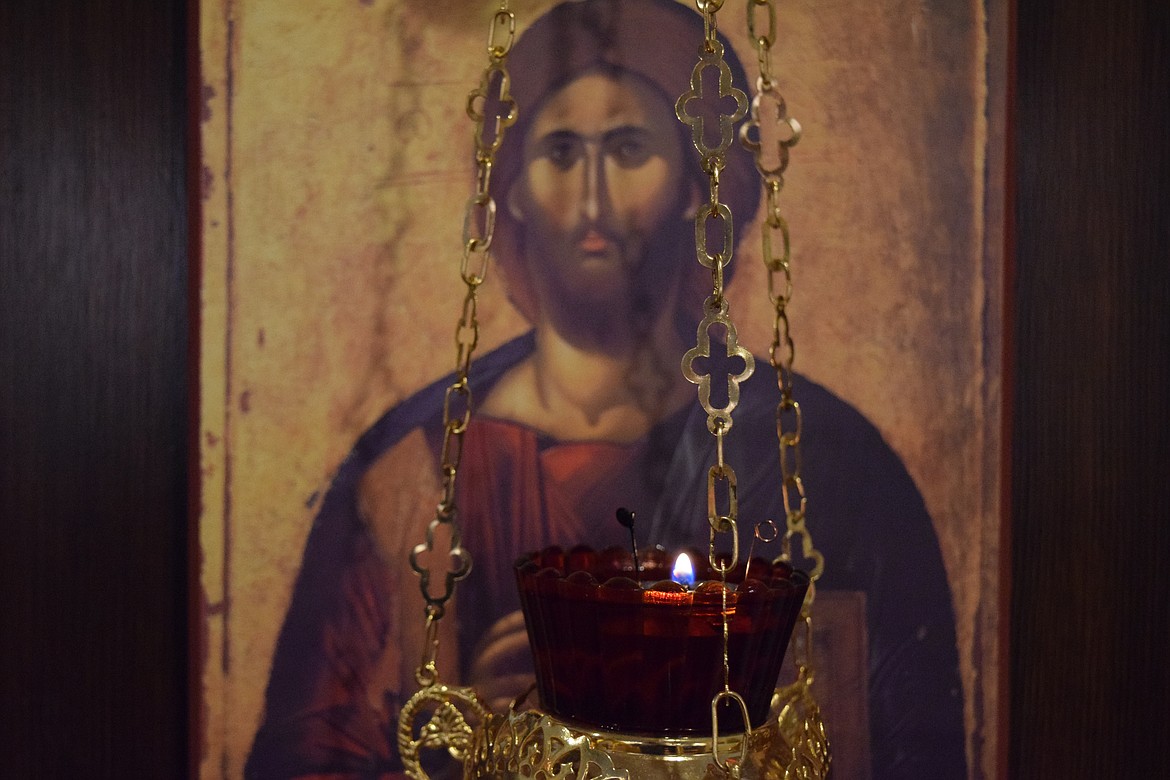 A candle hangs in front of a picture of Jesus Christ in the Moses Lake Orthodox Fellowship Chapel.