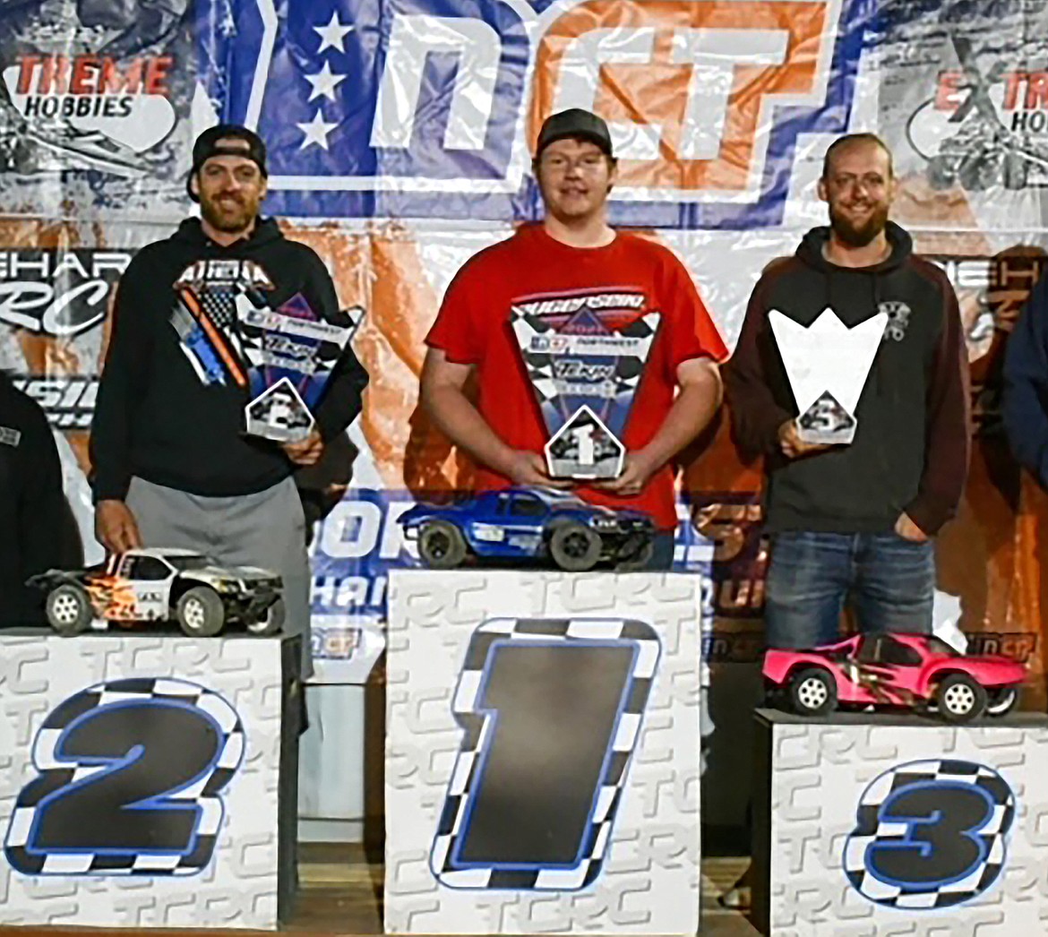 Gage Tweedie, center, holds his first-place Northwest Championship Tour award after claiming the tournament's top honors for the season. Rett Long, left, claimed second-place honors, and Daniel Price, right, finished in third for the tour.