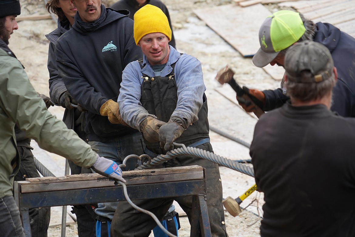 Workers splice together the ends of the heavy cable that will carry riders on Chair 8, which was recently relocated in the Hellroaring Basin at Whitefish Mountain Resort. (Courtesy of Whitefish Mountain Resort)