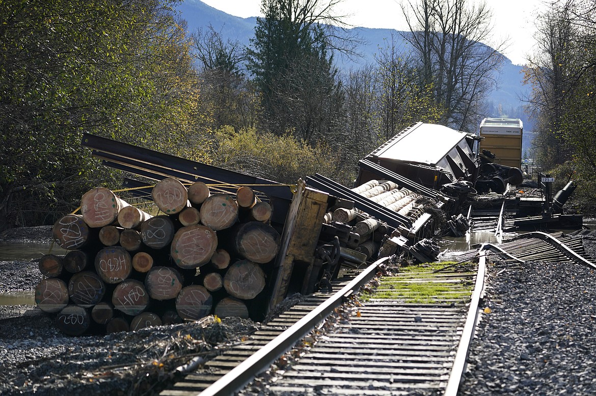 Derailed railroad cars sit near flood-damaged tracks at a BNSF rail yard Wednesday, Nov. 17, 2021, in Sumas, Wash. An atmospheric river—a huge plume of moisture extending over the Pacific and into Washington and Oregon—caused heavy rainfall in recent days, bringing major flooding in the area. (AP Photo/Elaine Thompson)