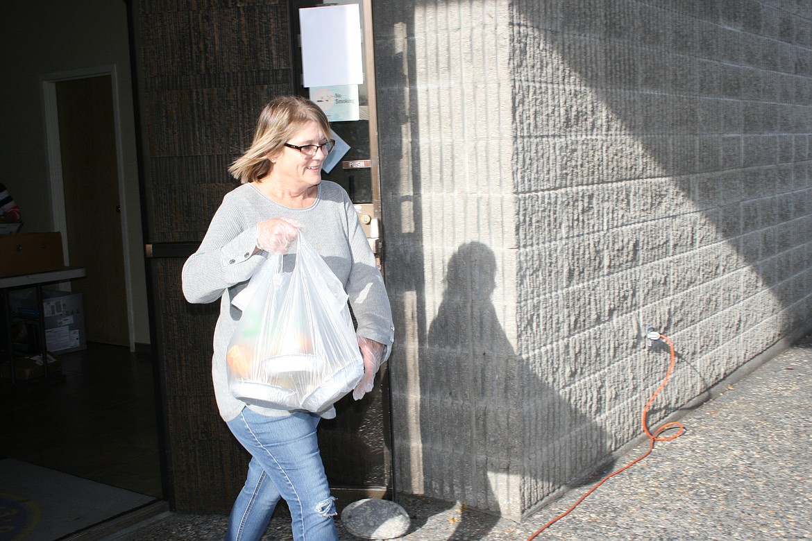 Jennifer Killian delivers a meal during the drive-thru community Thanksgiving dinner Wednesday.