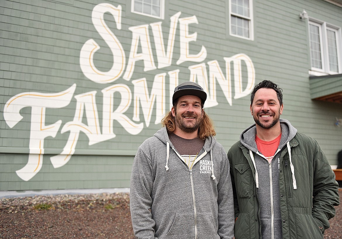 Craig McViney and Scot Chisholm stand outside the soon-to-be Haskill Creek Farms general store on Voerman Road in Whitefish where a Save Farmland mural was recently painted on the outside of the building. Save Farmland, a nonprofit created by Chisholm, is working to save agricultural land in Whitefish from further development while helping young farmers get started in the industry. (Whitney England/Whitefish Pilot)