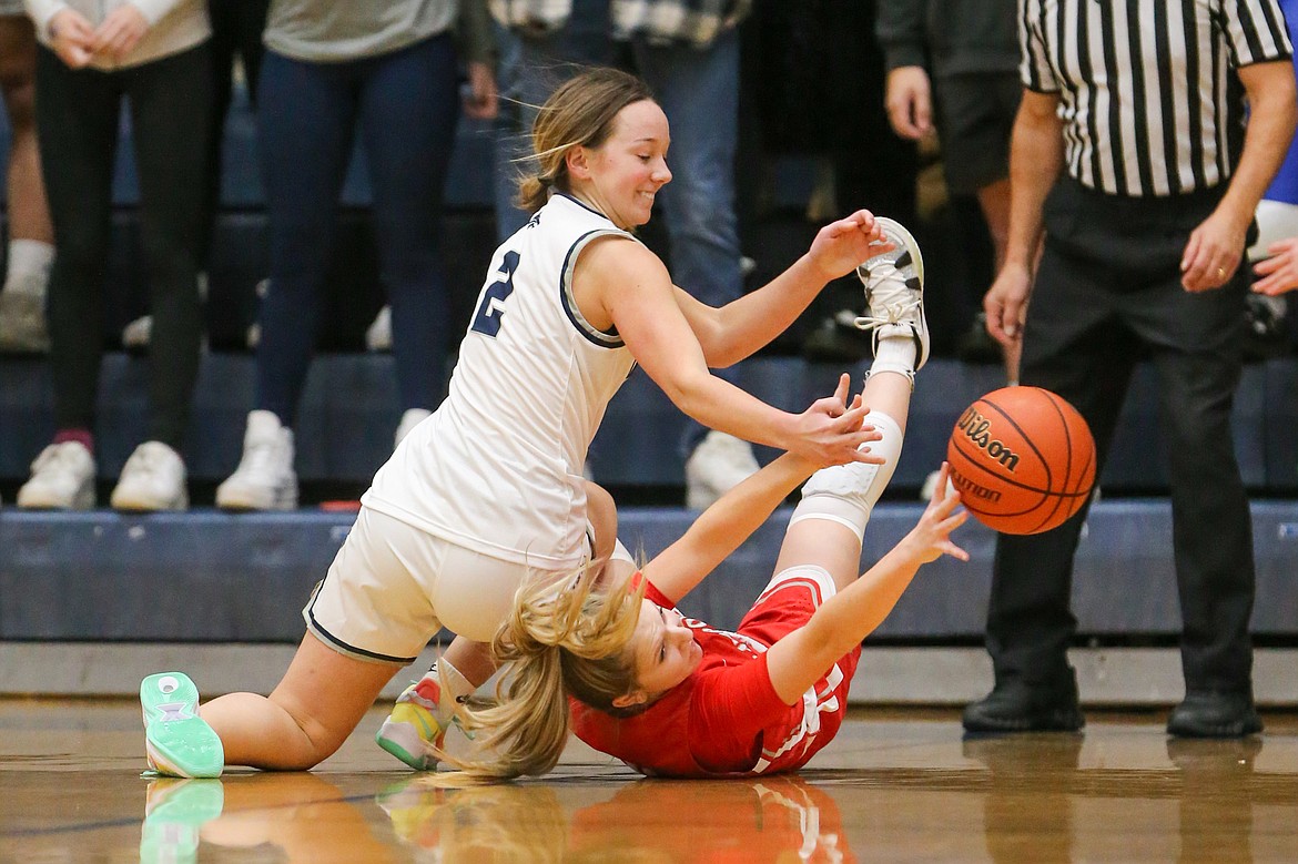 Junior Daylee Driggs battles for a loose ball with Lake City's Kamryn Pickford on Thursday.