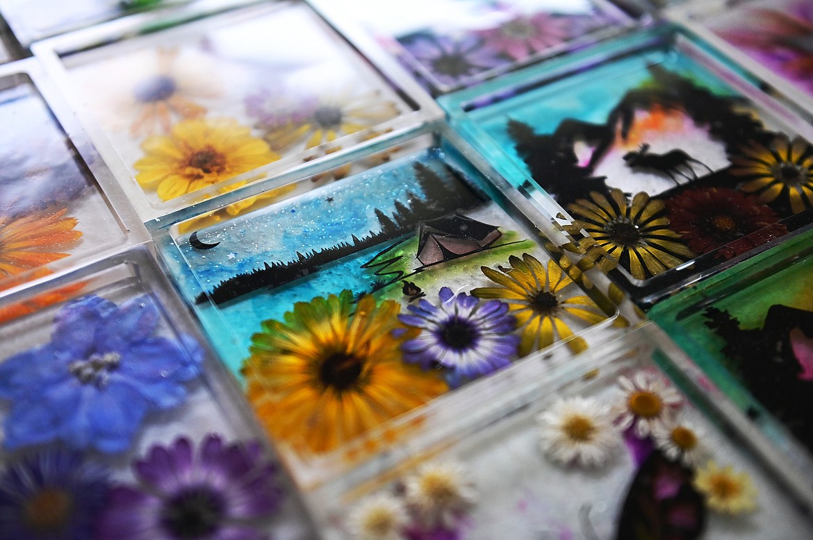 Lindsay Mena, president of Artists and Craftsmen of the Flathead, grows her own flowers and encases them in epoxy resin to create colorful coasters, stove spoon rests, nightlights, keychains and more. (Casey Kreider/Daily Inter Lake)