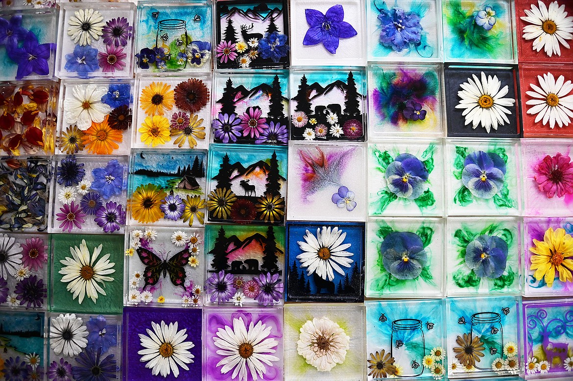 Lindsay Mena, president of Artists and Craftsmen of the Flathead, grows her own flowers and encases them in epoxy resin to create colorful coasters, stove spoon rests, nightlights, keychains and more. (Casey Kreider/Daily Inter Lake)